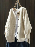 Cream oversized cable knit cardigan with button front and chunky knit texture