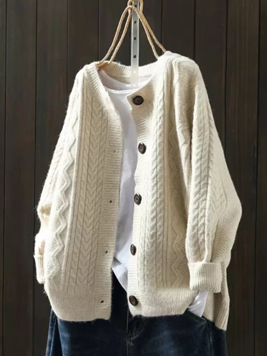 Cream oversized cable knit cardigan with button front and chunky knit texture