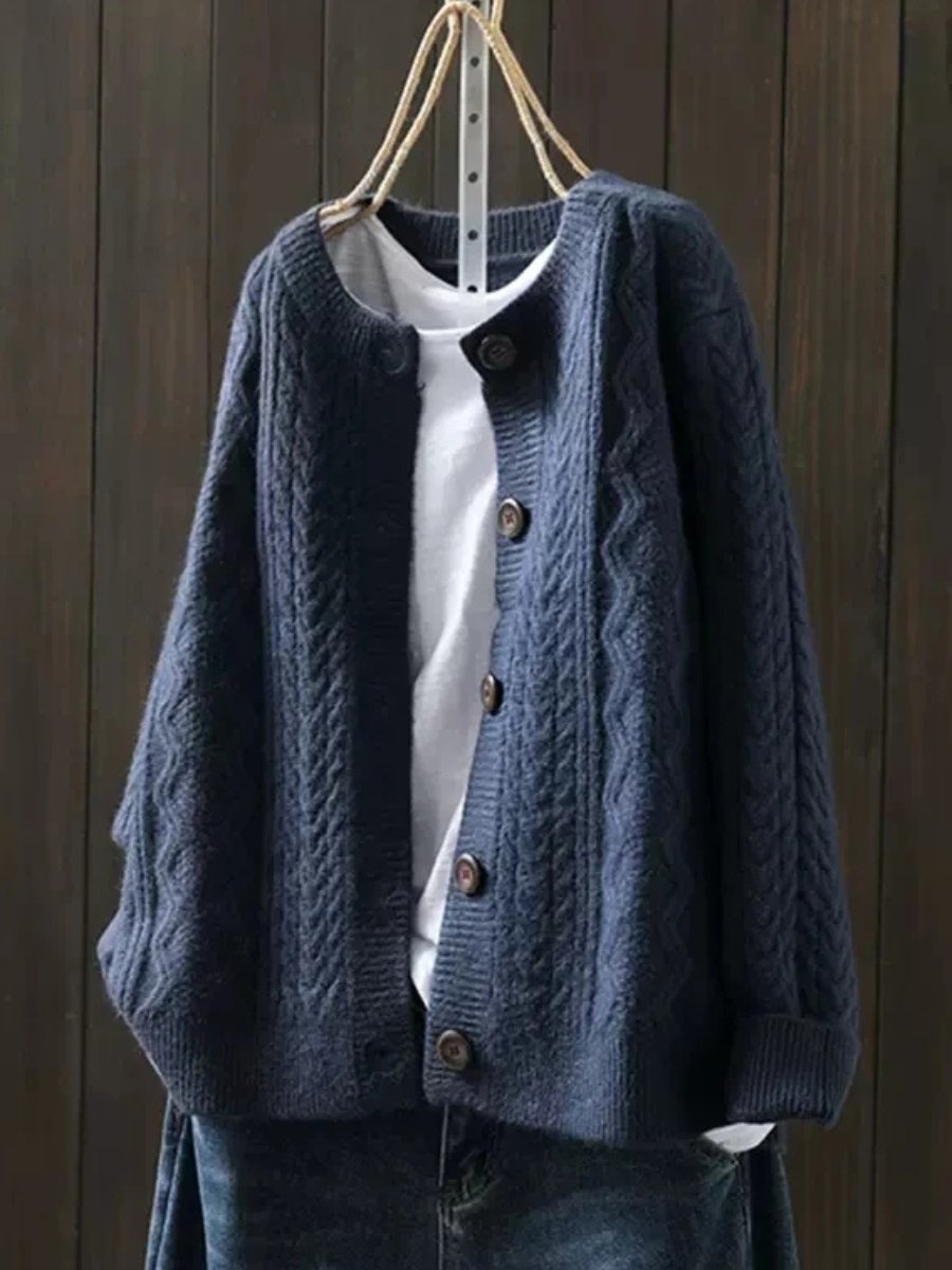 Blue oversized cable knit cardigan with button front and textured knit panels
