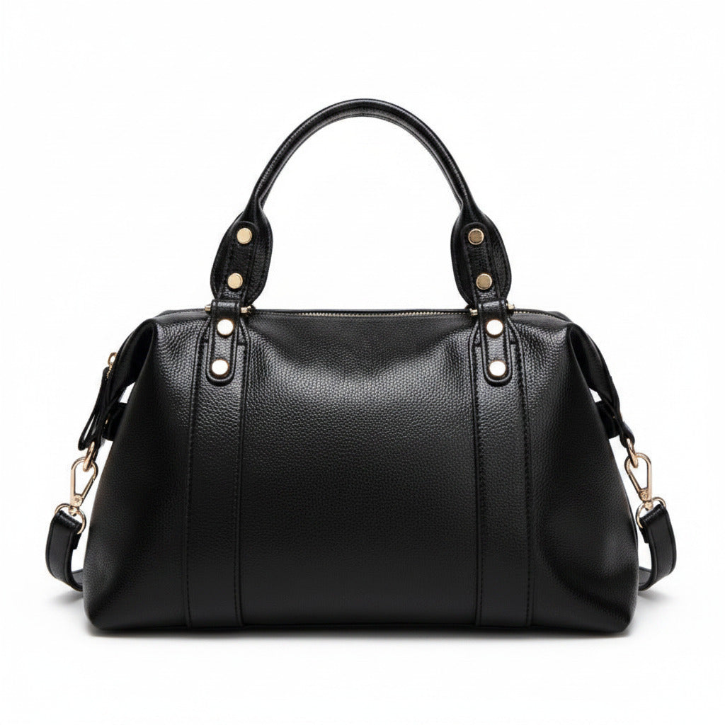 Black leather-style Boston handbag with top handles, gold hardware, and side tassel details.