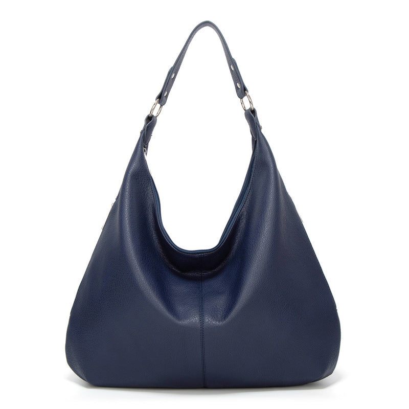 Navy blue textured leather hobo bag with two top handles and open curved front.
