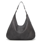 Grey textured leather hobo bag with two top handles and open curved front.