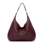 Burgundy textured leather hobo bag with two top handles and open curved front.