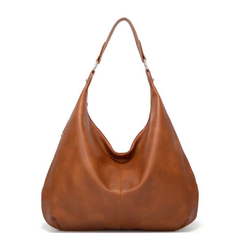 Camel brown textured leather hobo bag with two top handles and open curved front.