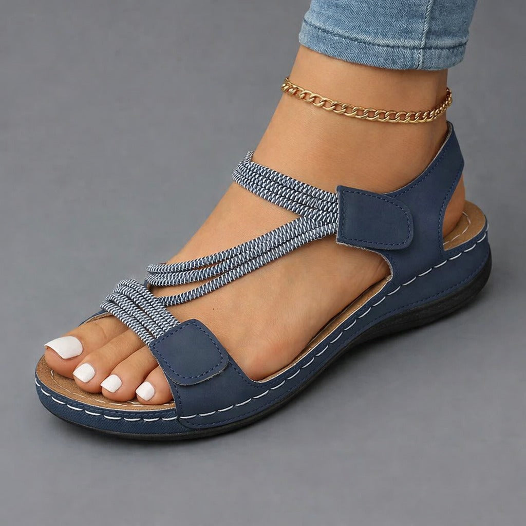 Blue strappy sandals with adjustable hook-and-loop straps and cushioned sole