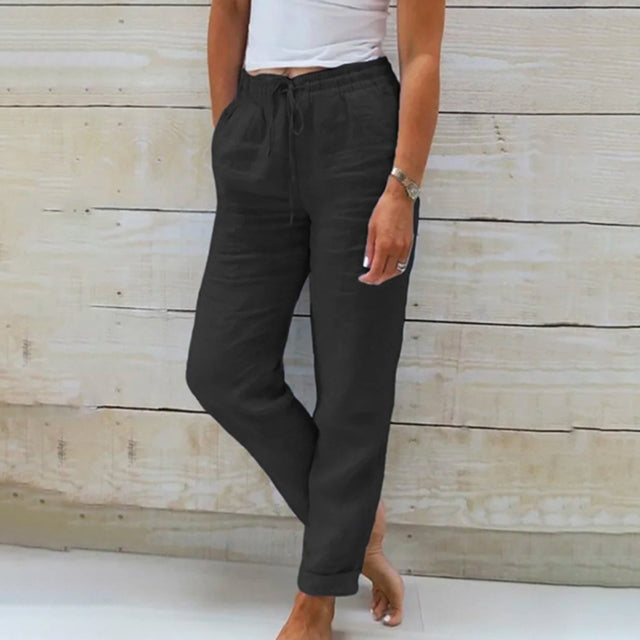 Black wide-leg drawstring trousers with relaxed fit and cuffed hems