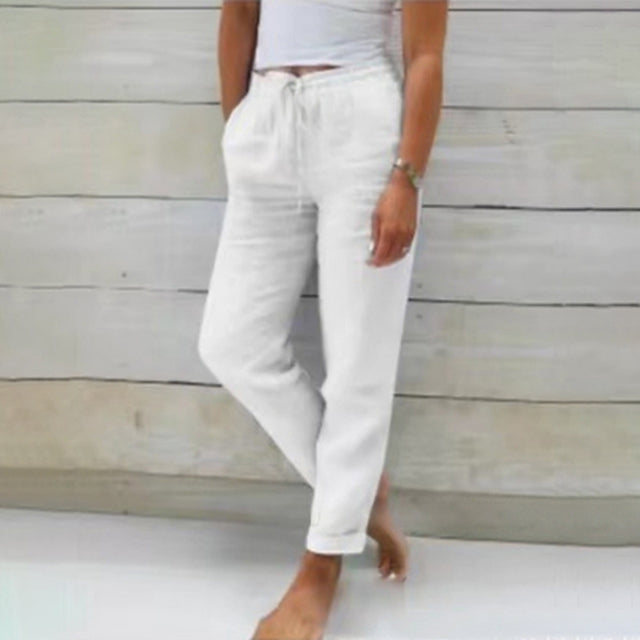White wide-leg drawstring trousers with relaxed fit and cuffed hems