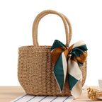 Woven summer tote bag in khaki with long handles and teal-and-cream ribbon bow