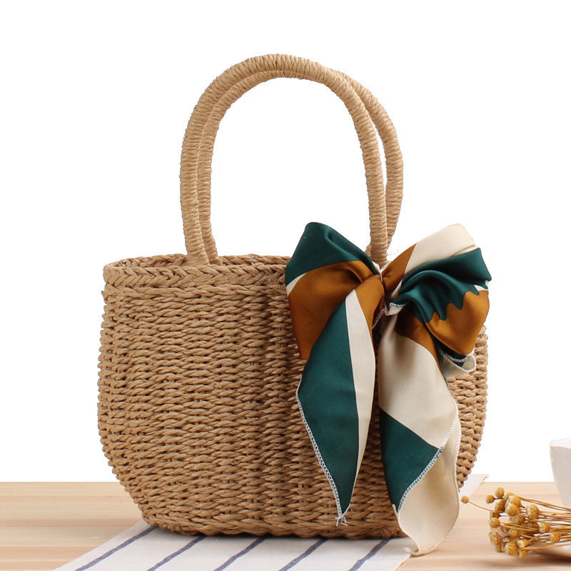Woven summer tote bag in khaki with long handles and teal-and-cream ribbon bow