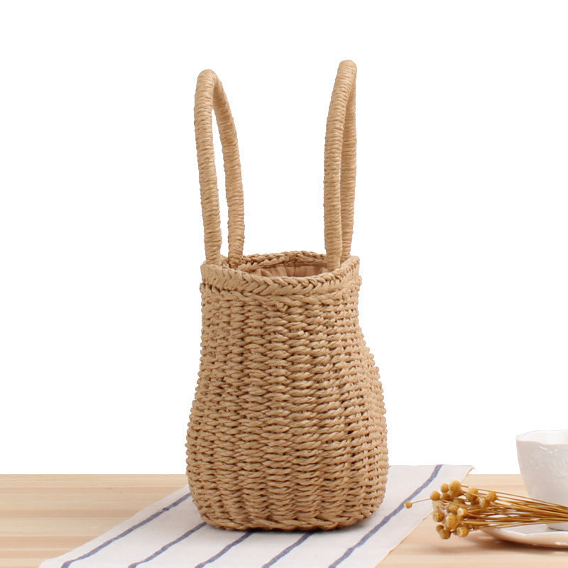 Woven khaki tote bag with long loop handles and compact rounded woven body