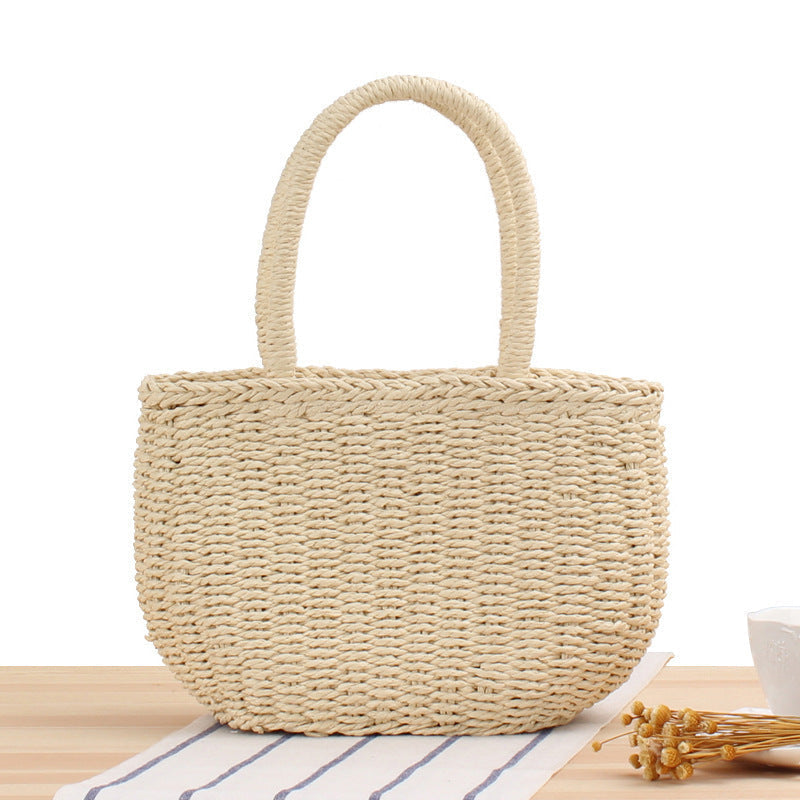 Woven straw tote bag with centered rounded top handles and structured body