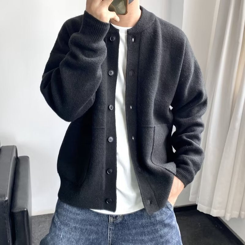 Black button-front luxury sweater with side pockets and ribbed cuffs