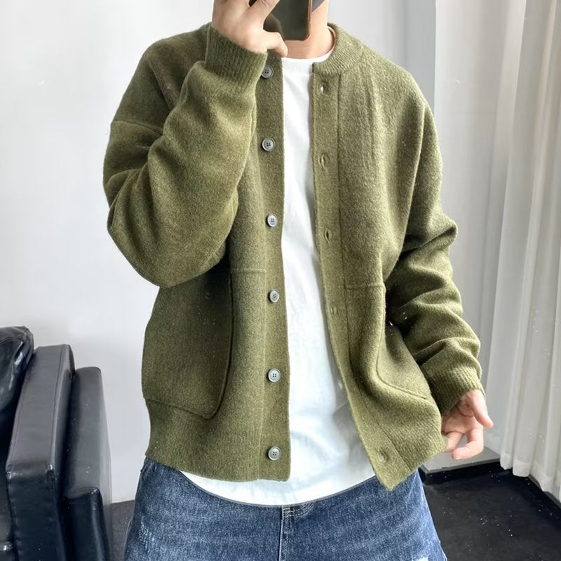 Green button-front luxury sweater with side pockets and ribbed hem