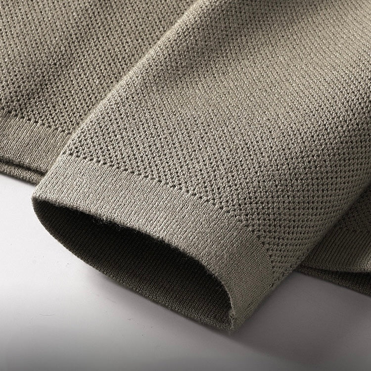 Beige blazer cuff close-up with woven texture and hem finish