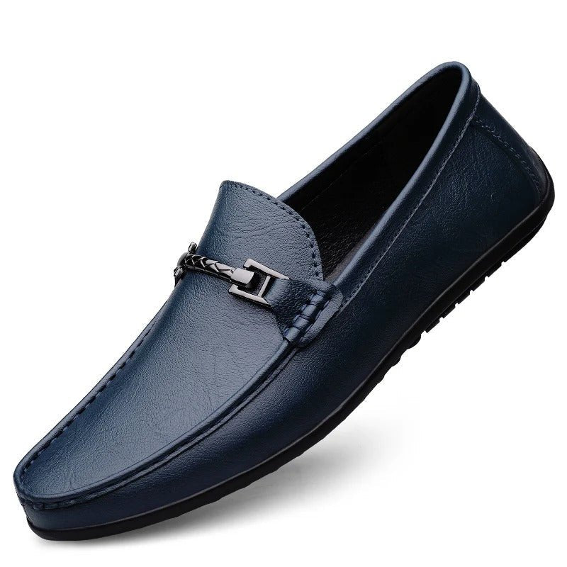 Men’s blue leather slip-on loafer with strap-and-buckle detail and rubber sole