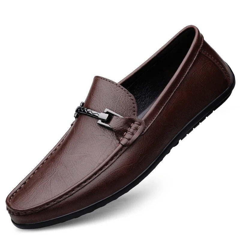 Men’s brown leather slip-on loafer with strap-and-buckle detail and rubber sole