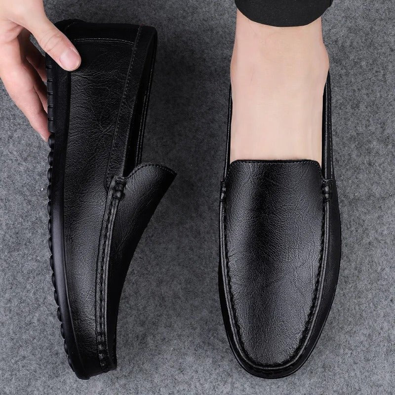 Men’s black leather slip-on loafer with moc toe stitching and padded collar
