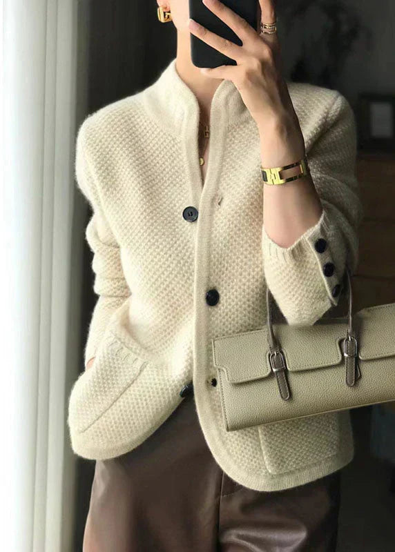 Off-white knit cardigan with front buttons, textured pattern, and long sleeves