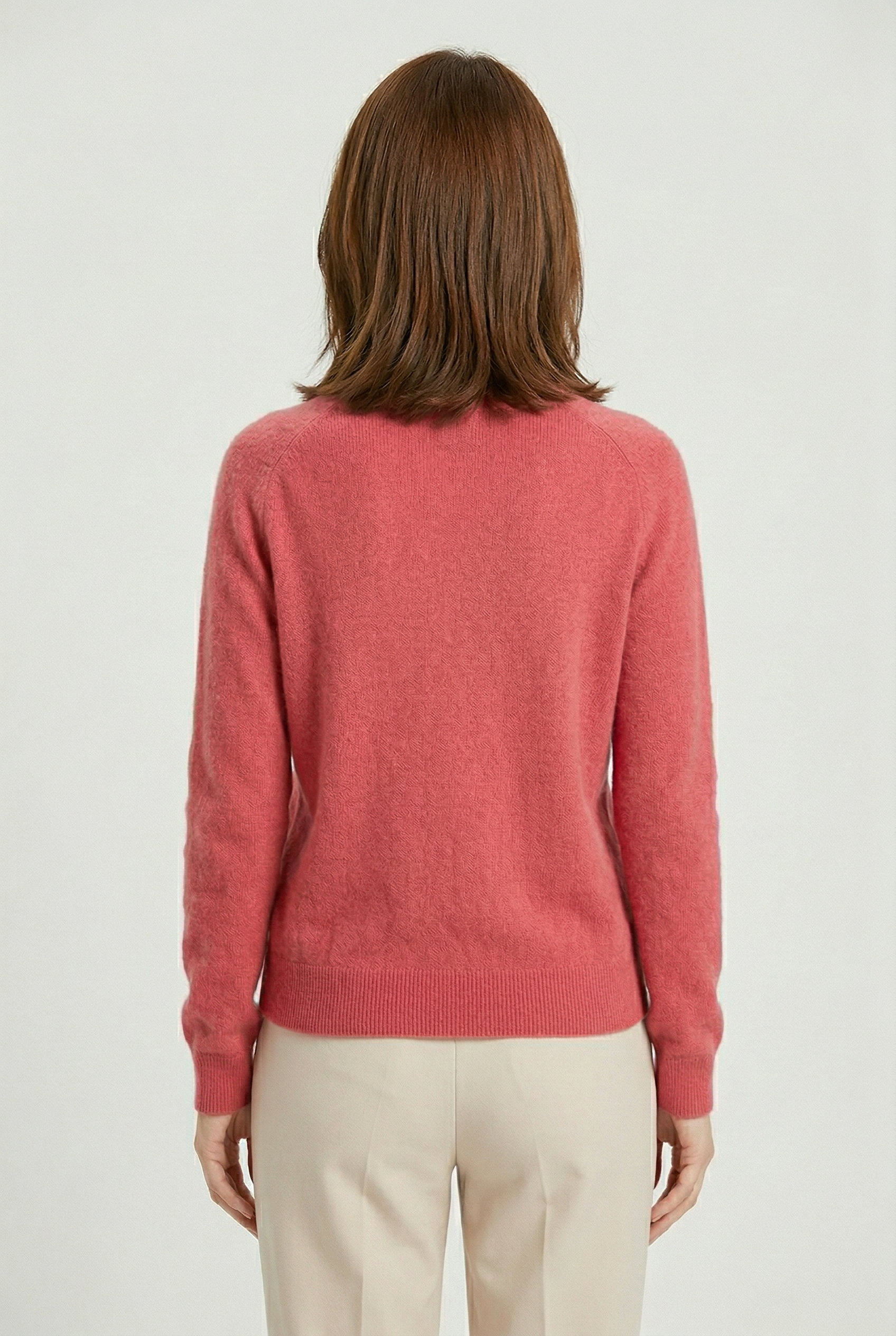 Women’s pink V-neck button cardigan from the back with long sleeves