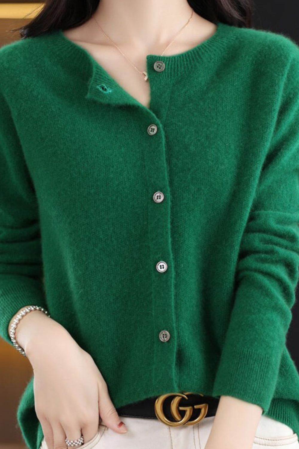 Women’s V-neck button cardigan in deep green, long sleeves, centered button placket.