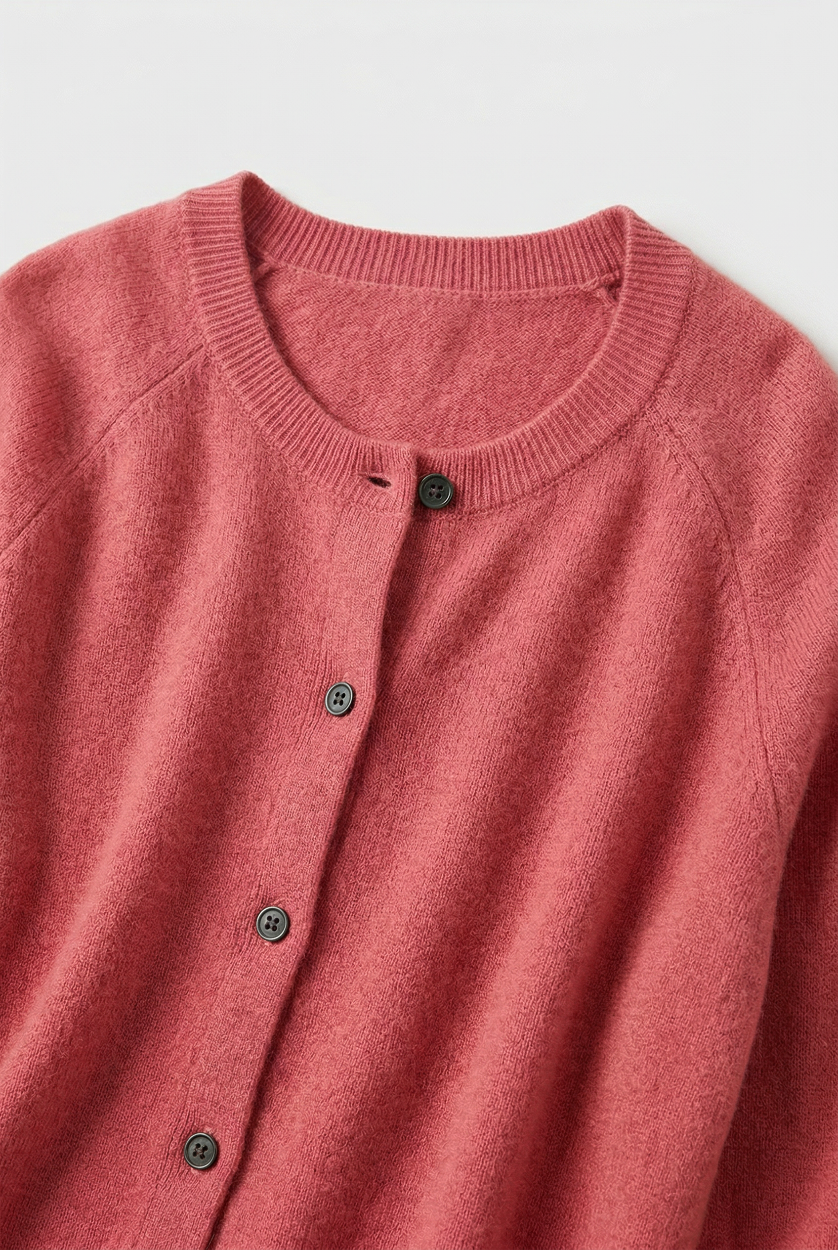 Women’s pink V-neck button cardigan with ribbed trim and dark button placket