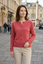Women’s pink V-neck button cardigan with long sleeves and dark buttons, front view