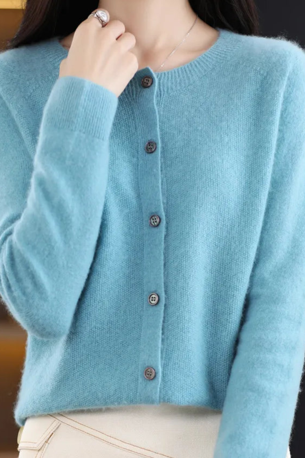 Women’s light blue V-neck button cardigan with long sleeves and dark button front