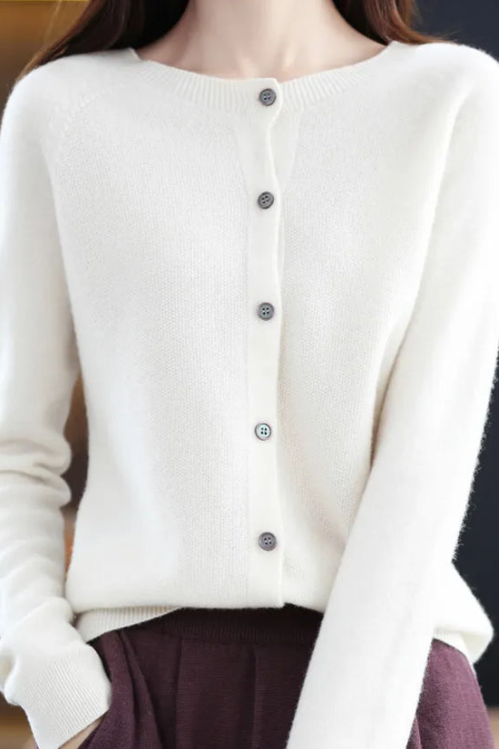 Women’s white V-neck button cardigan with long sleeves and dark button front
