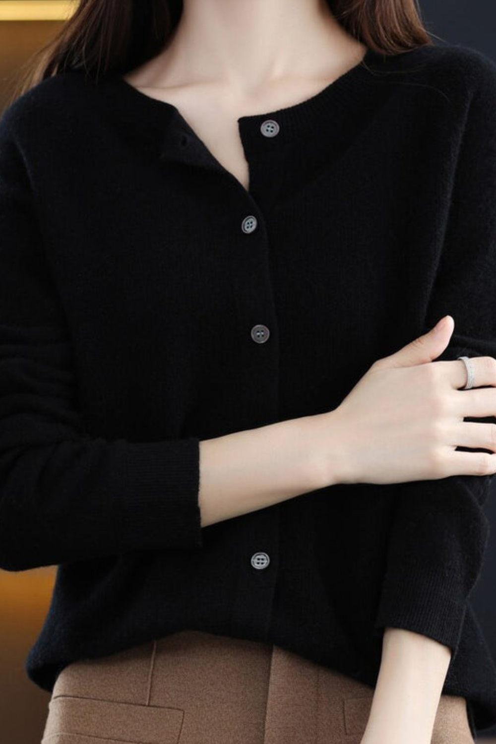 Women’s black V-neck button cardigan with long sleeves and dark button placket