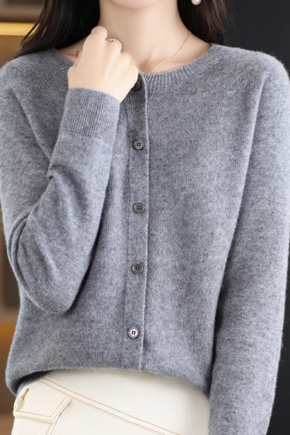 Women’s light gray V-neck button cardigan with long sleeves and dark buttons