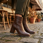 Brown ankle fit block heel boots with smooth finish, rounded toe, pull-on style.