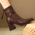 Brown ankle boots with block heel, side zipper detail, and diagonal seam design