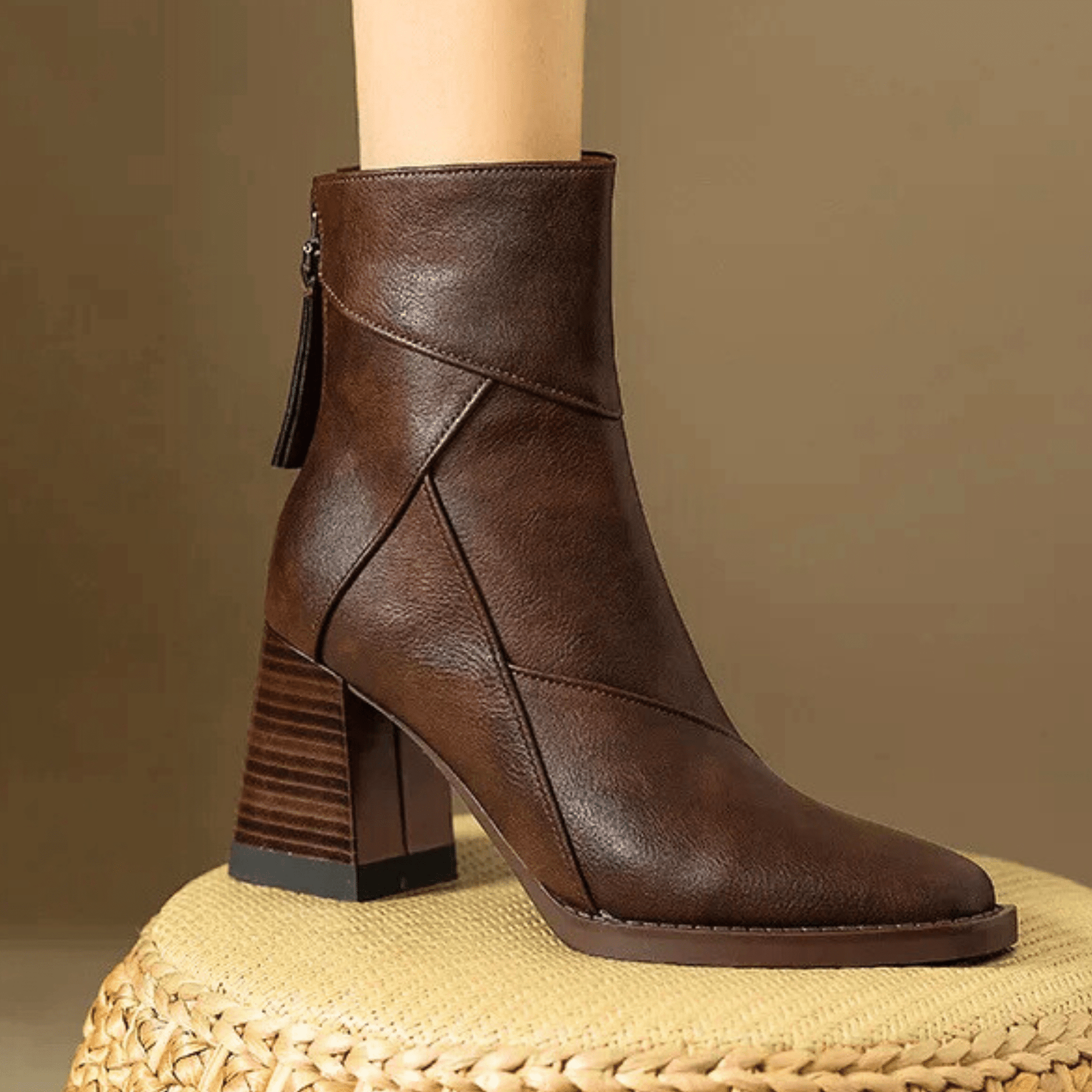 Brown ankle boots with block heel, tassel side pull, and crisscross stitching