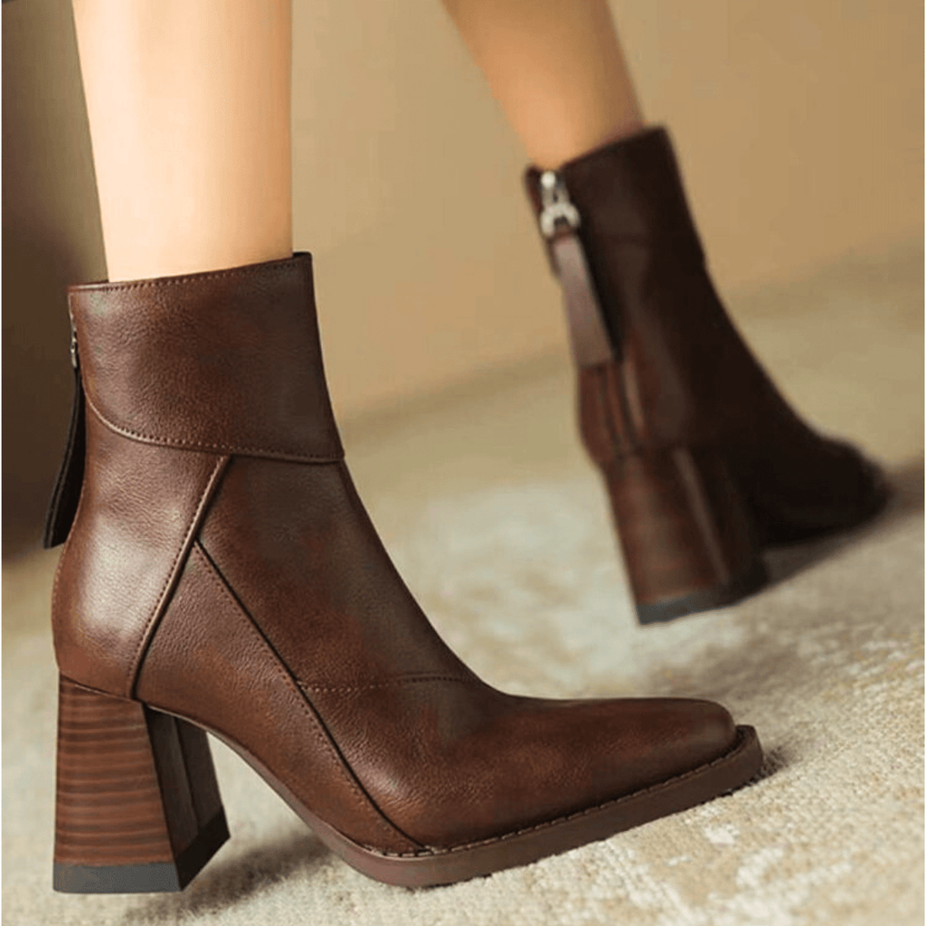 Brown ankle boots with block heel and diagonal seam styling, side tassel pull