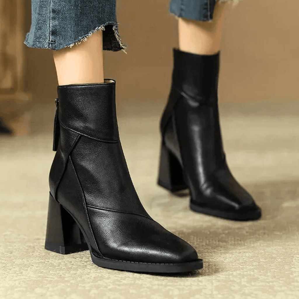 Black ankle boots with block heels, smooth leather look, and side cuff opening