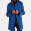 Blue winter coat with high collar, button front, and flap pockets at the sides