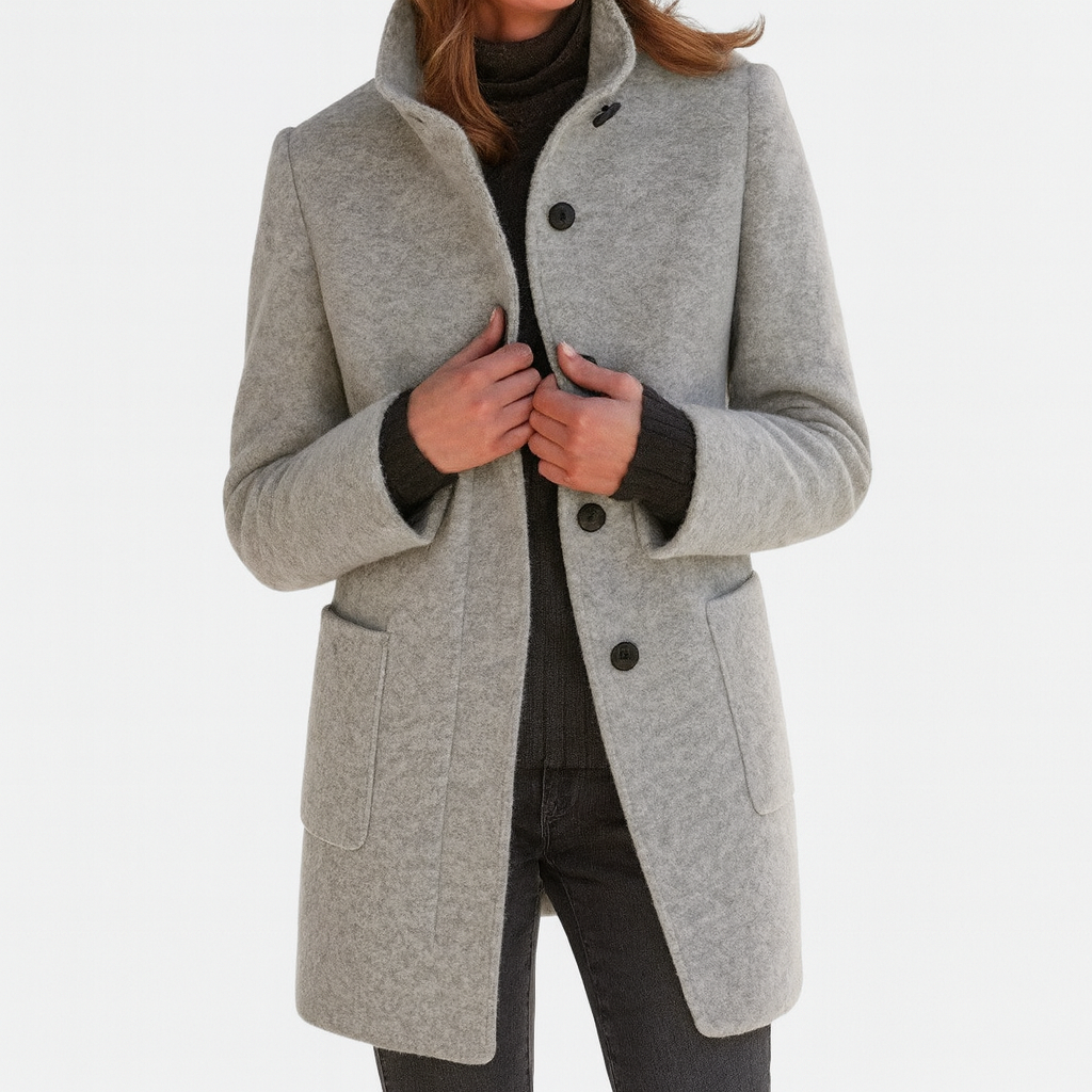 Grey winter coat with high collar, button front, and flap pockets along the sides