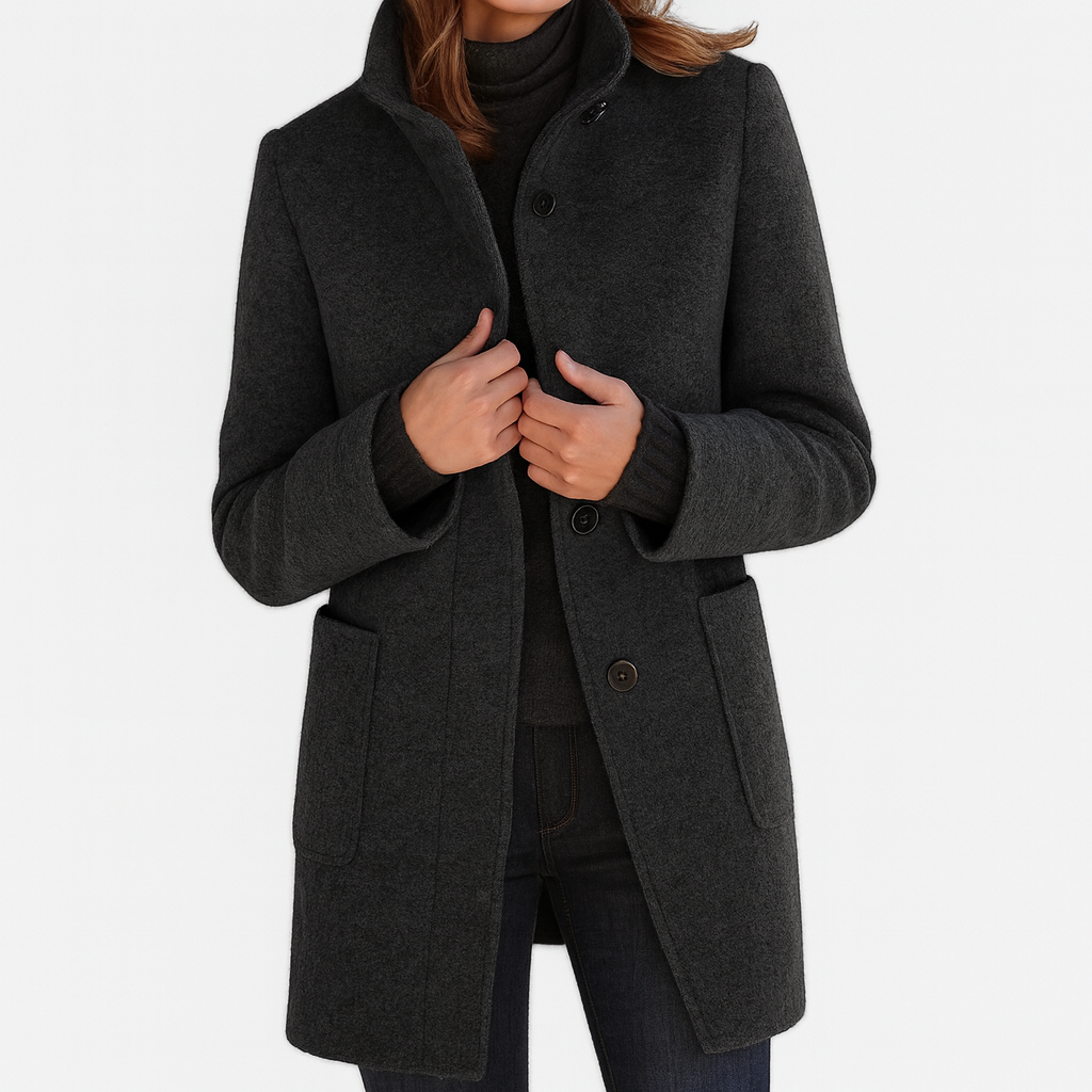 Black winter coat with high collar, button front, and flap pockets on the sides