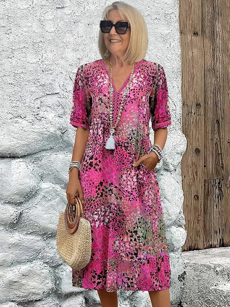 Women's floral V-neck midi dress in bright pink, short sleeves, tassel tie detail
