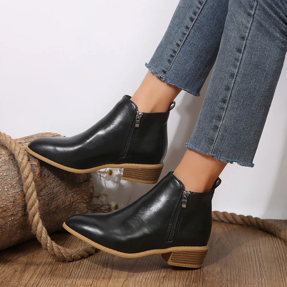 Women’s black side-zip ankle boots with tan sole edge and mid block heel