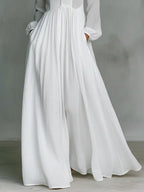 White women's maxi dress with gathered waist and flowing A-line skirt