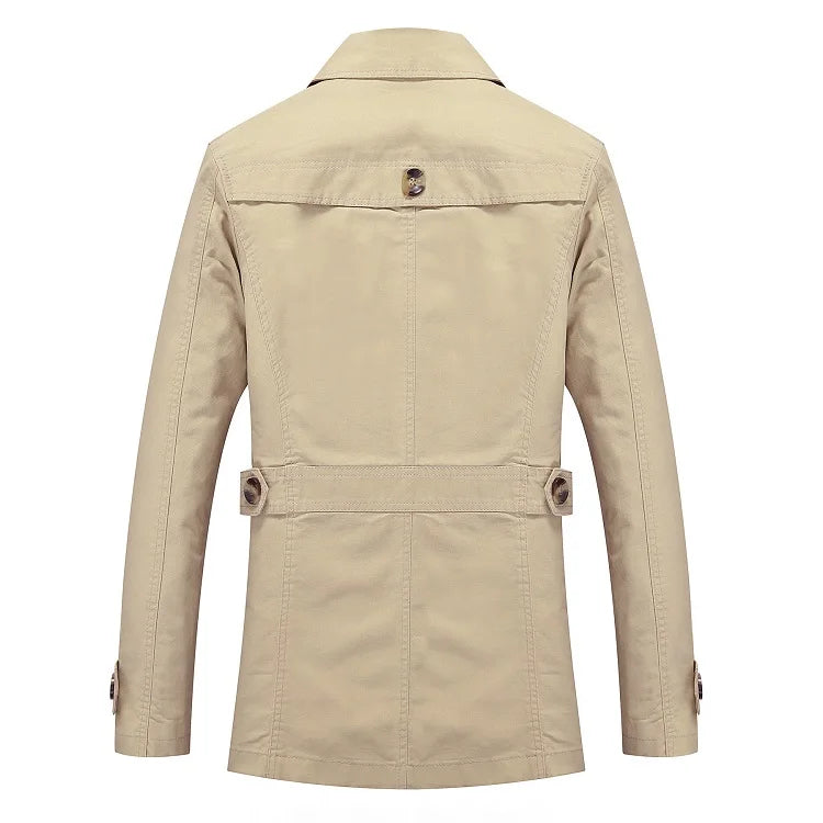 Beige trench coat back view with yoke seam and storm flap detail at waist.