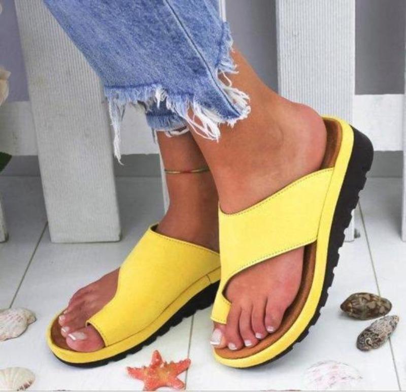 Yellow backless platform slide sandals with V-shaped upper and ridged outsole