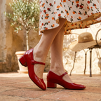 Red Mary Jane block heels with ankle strap and glossy round toe, low heel.