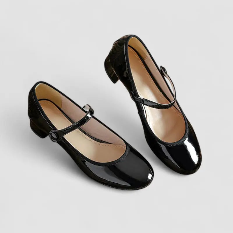 Black Mary Jane shoes with shiny finish and ankle strap, two pairs shown