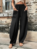 Relaxed wide-leg palazzo trousers in black with elastic waist and roomy drape