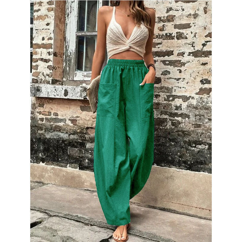 Relaxed wide-leg palazzo trousers in green with elastic waistband and gathered, loose legs