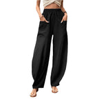Relaxed wide-leg palazzo trousers in black with elastic waist and wide, tapered drape