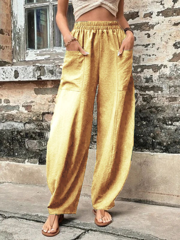 Relaxed wide-leg palazzo trousers in light yellow with elastic waist and roomy straight legs