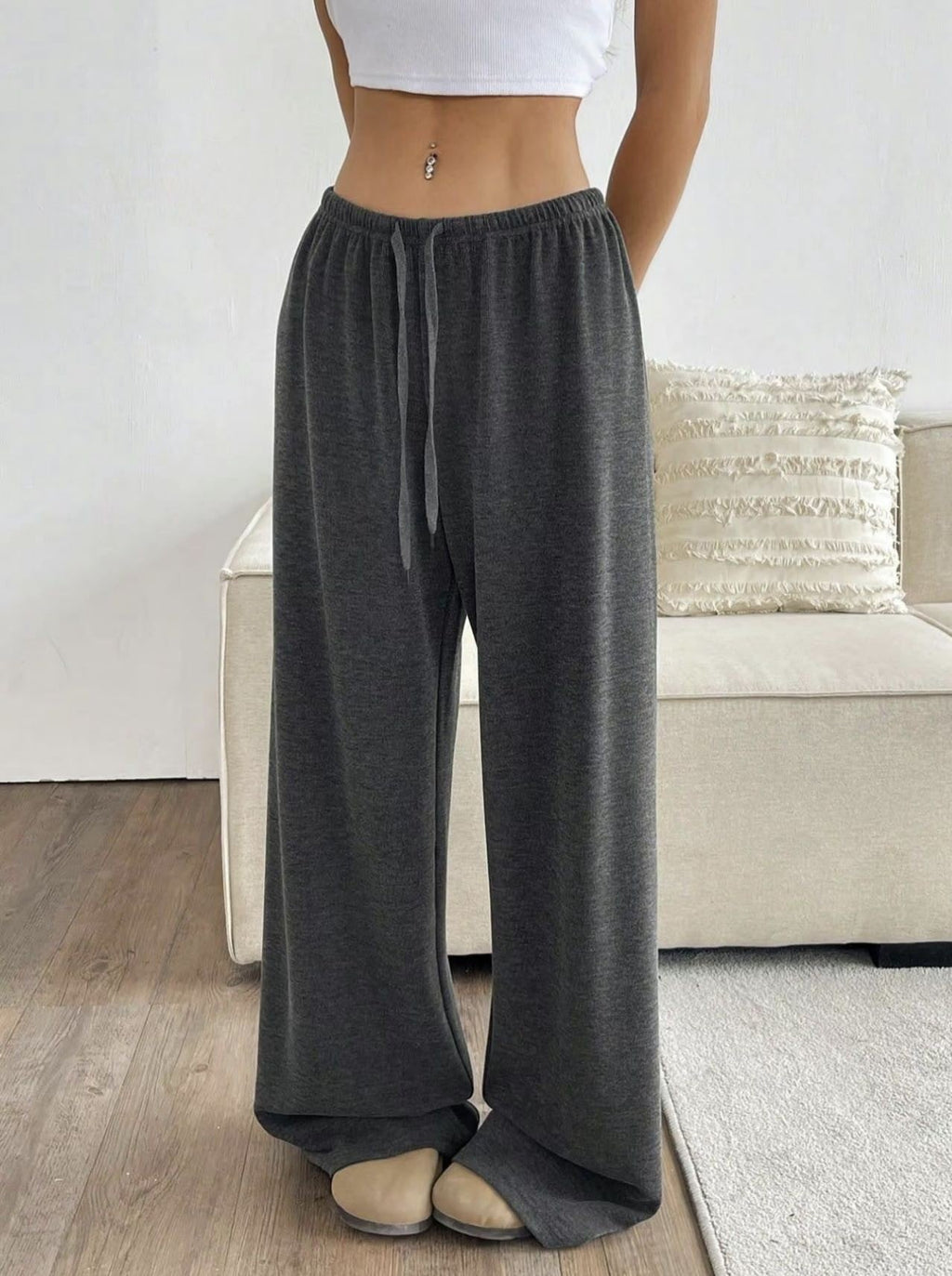 Dark gray wide-leg sweatpants with elastic waistband and drawstring, full length